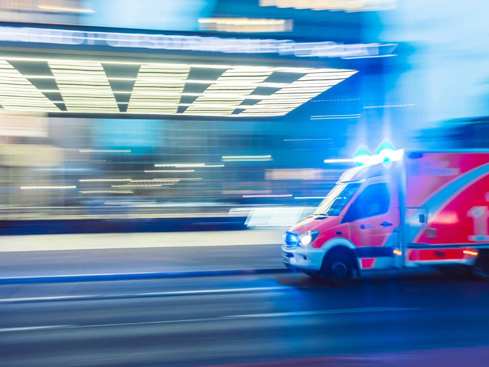 Ambulance in motion with emergency lights flashing