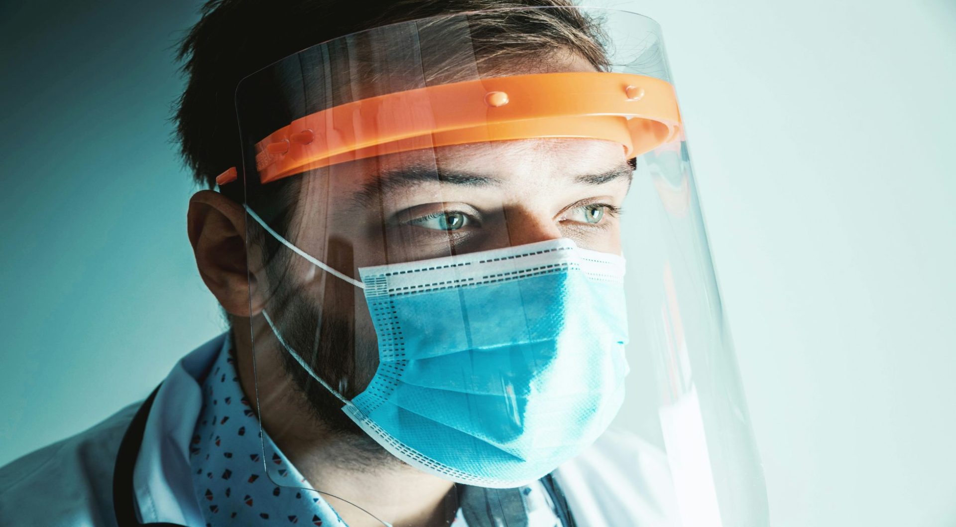 Doctor in face shield and mask, focused