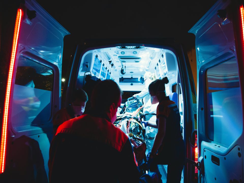 Medical team working inside an ambulance at night