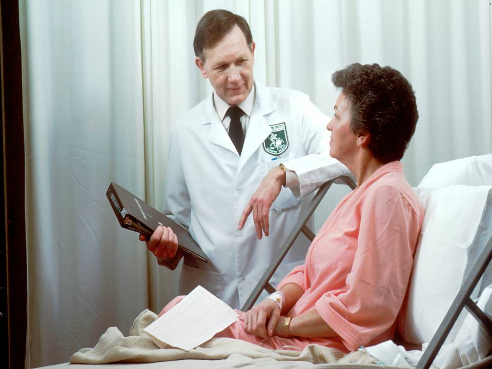 Doctor consulting a patient in hospital gown